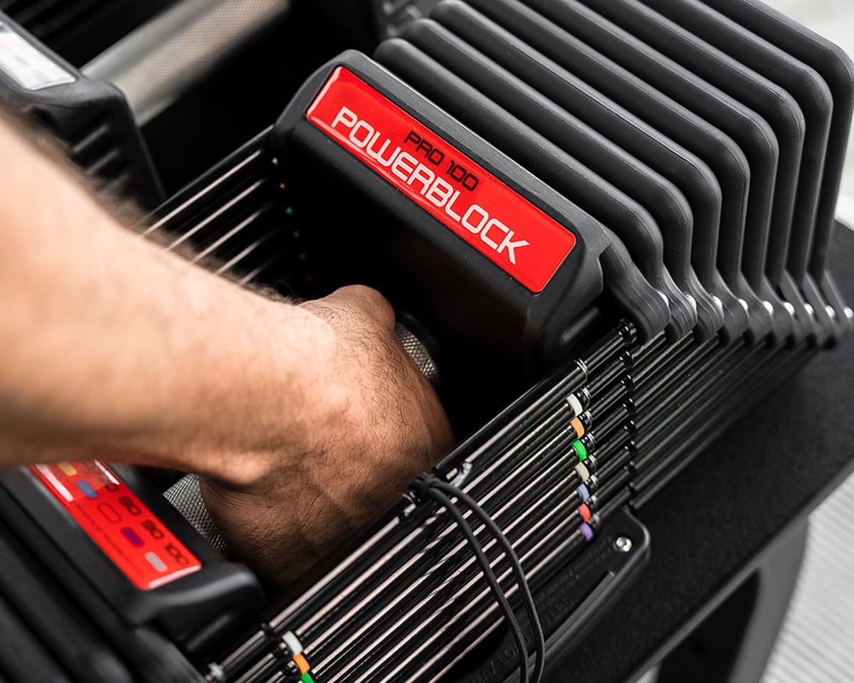 PowerBlock Pro 100 picking up dumbbell